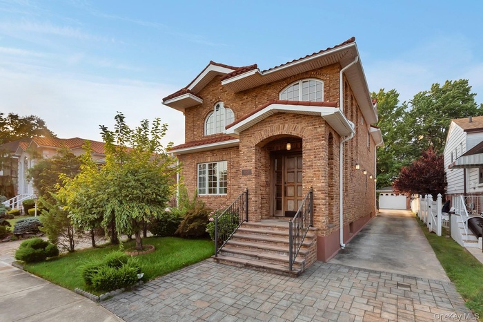 View of front of house with brick siding and a front yard
