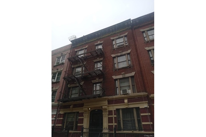 View of apartment building / complex featuring cooling unit