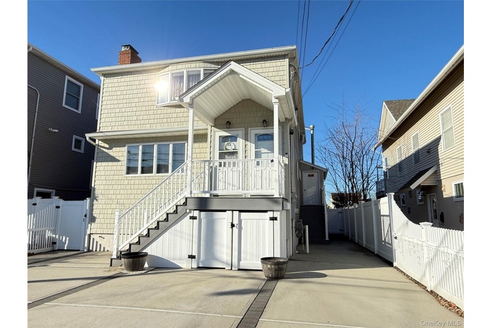 View of front of property with a chimney and a gate