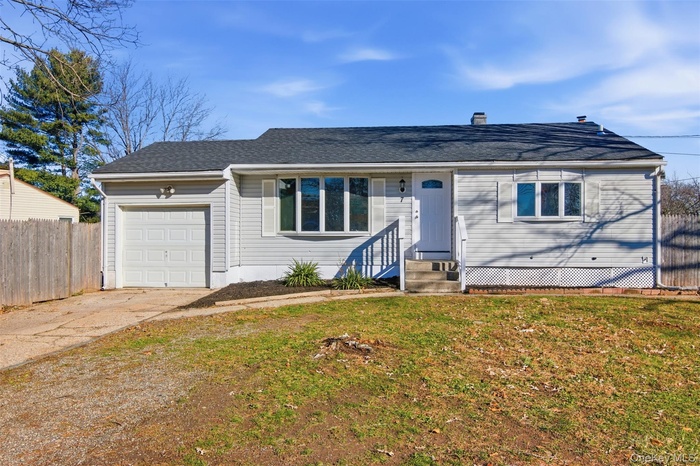 View of front of home with a garage, a shingled roof, and concrete driveway