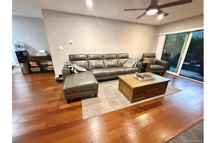 Living room featuring wood finished floors and ceiling fan