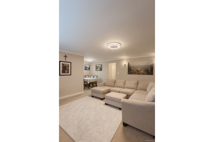Living room with carpet and crown molding