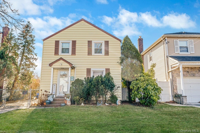 View of front of home featuring a gate