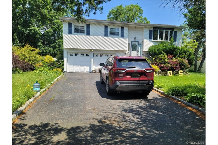 Raised ranch featuring driveway and a garage