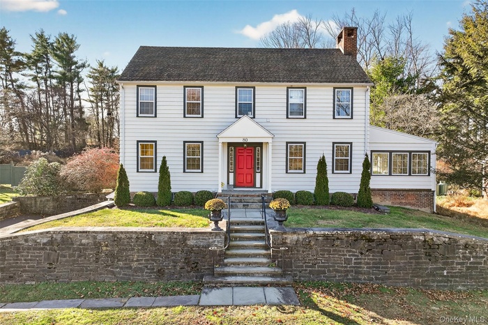 Colonial inspired home featuring a chimney