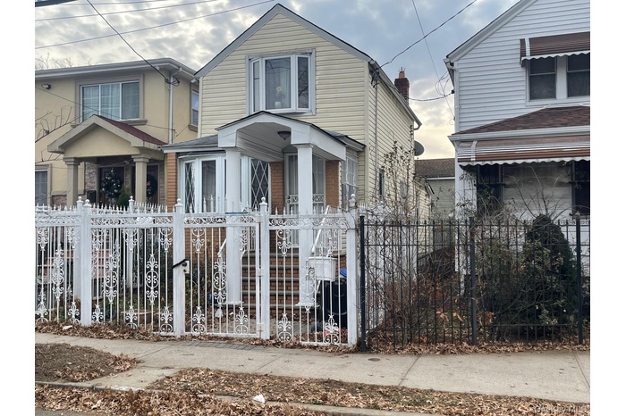 Traditional-style house featuring a fenced front yard