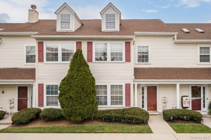 View of front of property featuring roof with shingles and a chimney