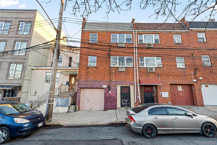 View of apartment building / complex featuring an attached garage