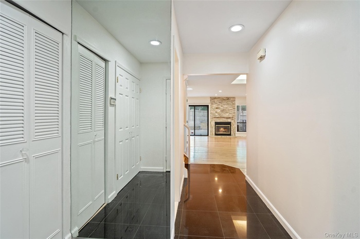 Hallway with recessed lighting and dark tile patterned flooring