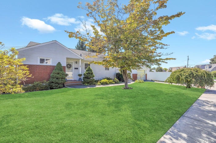 Single story home featuring brick siding and a shingled roof