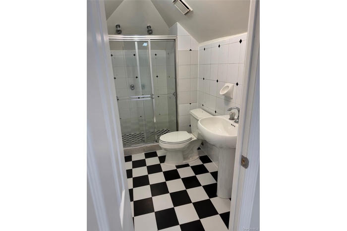Livingroom with recessed lighting, light tile patterned flooring, and a baseboard radiator