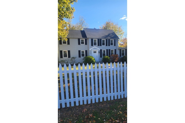 Colonial house with a fenced front yard