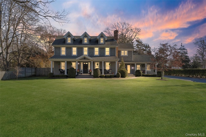 View of front of home with covered porch and a chimney