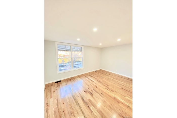Unfurnished room featuring light wood finished floors and recessed lighting
