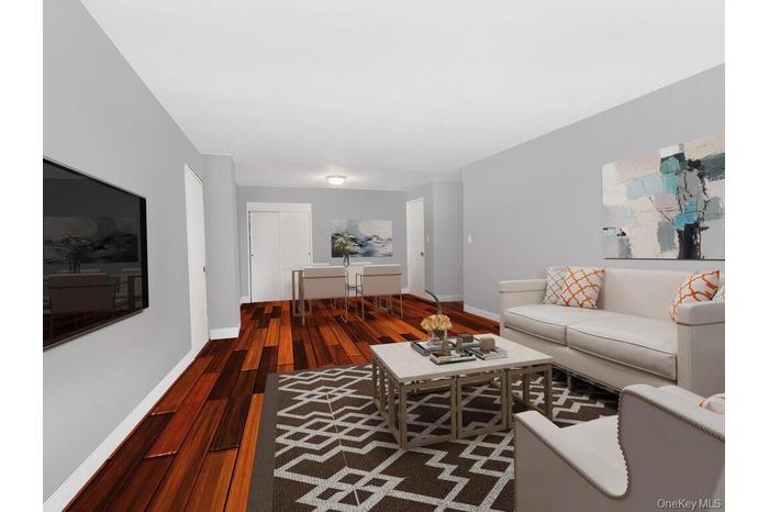 Living room featuring hardwood / wood-style flooring and baseboards