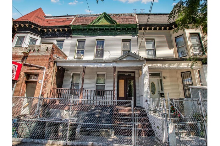 View of front of house with a gate, a fenced front yard, and covered porch