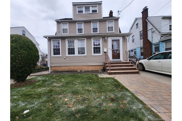 American foursquare style home with a chimney and a front yard