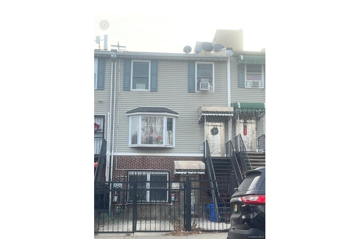 View of front of property featuring a fenced front yard and a gate