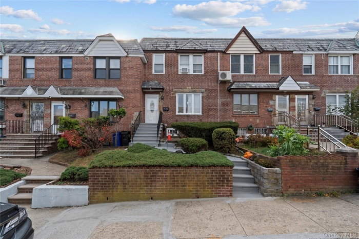 Traditional home with brick siding and a high end roof