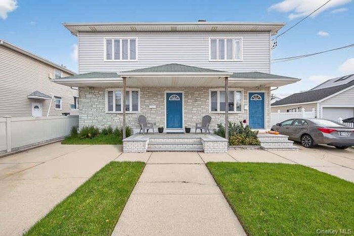 Traditional-style home featuring a porch and stone siding