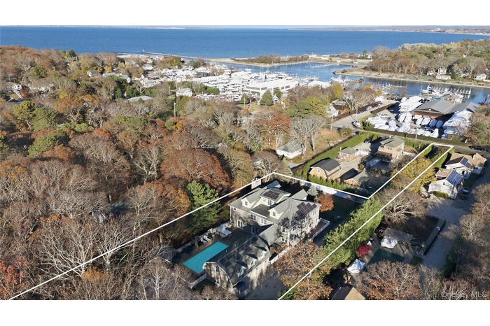 Aerial view of property's location featuring property parcel outlined and a large body of water
