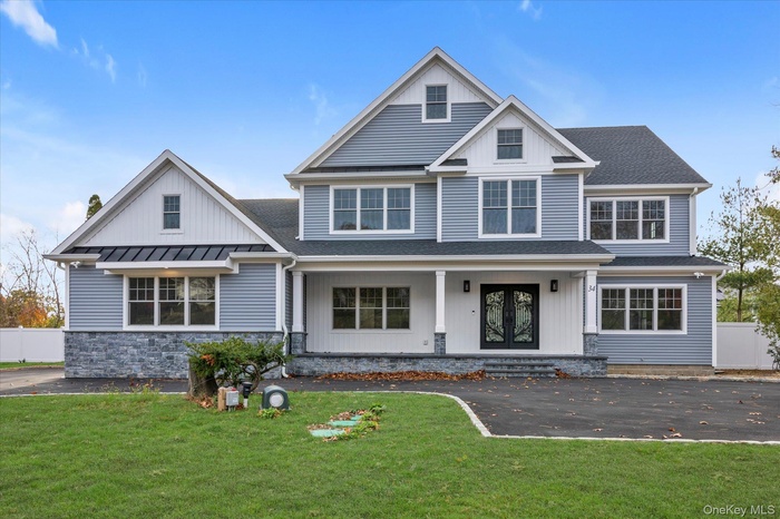 View of front of house featuring a porch, a shingled roof, and french doors