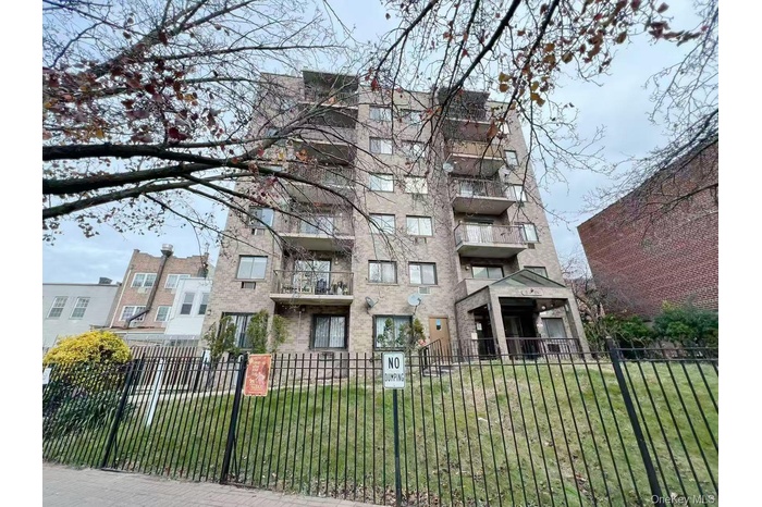 View of apartment building / complex featuring a fenced front yard