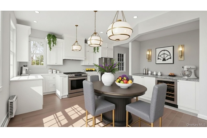 Kitchen featuring beverage cooler, appliances with stainless steel finishes, white cabinets, pendant lighting, and light wood-style floors