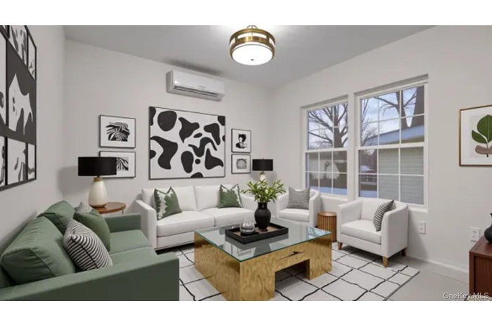 Living area featuring a wall mounted air conditioner and baseboards
