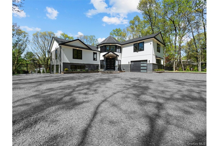 View of front of house featuring a garage and driveway
