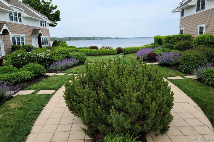 View of green lawn featuring a water view