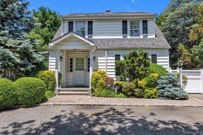 View of front of home featuring a shingled roof
