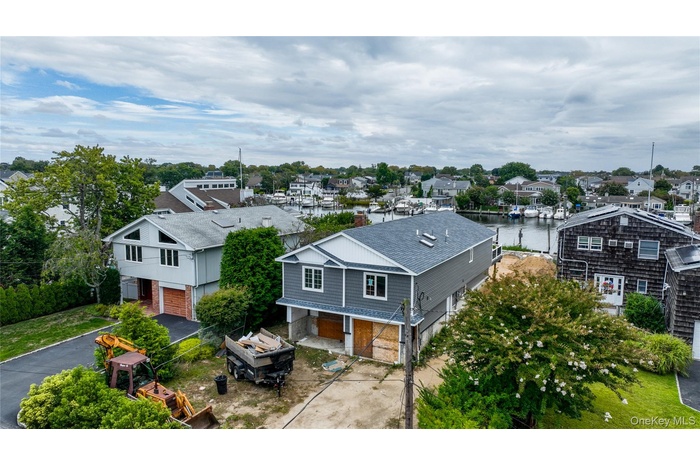 Aerial view of residential area featuring a nearby body of water
