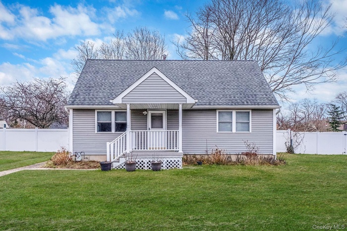 View of front of house with roof with shingles and a porch