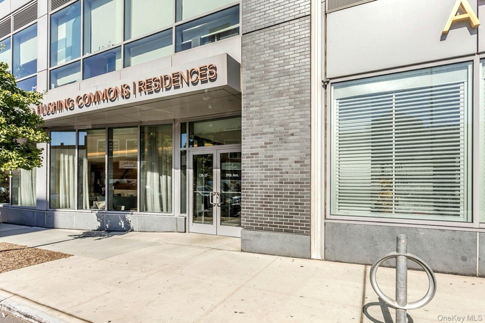 Doorway to property featuring brick siding and french doors