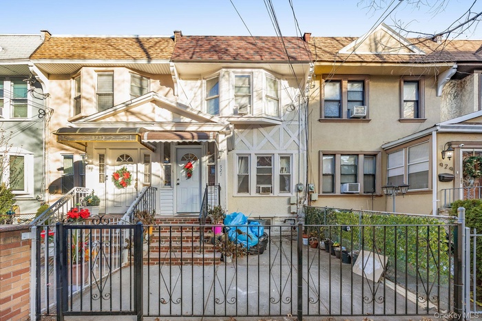 View of front of home featuring a fenced front yard, stucco siding, and a gate