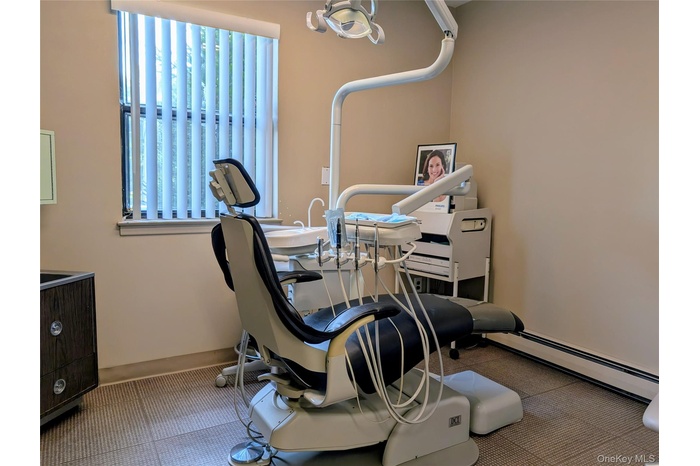 Workout area featuring baseboard heating and baseboards
