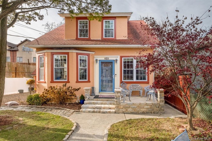 View of front of home with roof with shingles and stucco siding