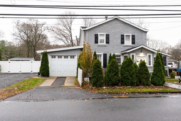 View of front of home featuring asphalt driveway