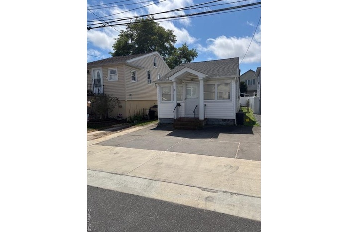 View of front of house with a shingled roof