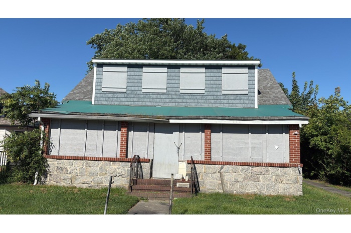 View of front of property featuring entry steps and roof with shingles