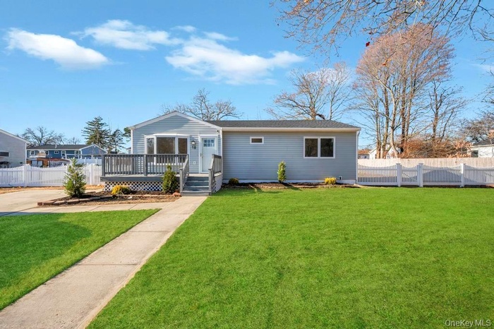 View of front of house featuring a wooden deck and a shingled roof
