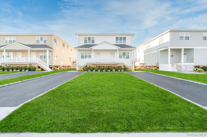 View of front of home with a porch and a front lawn