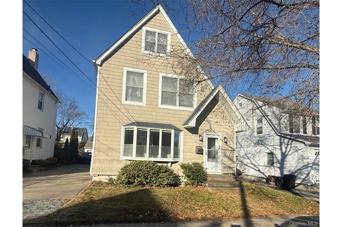 View of front of property with a front yard
