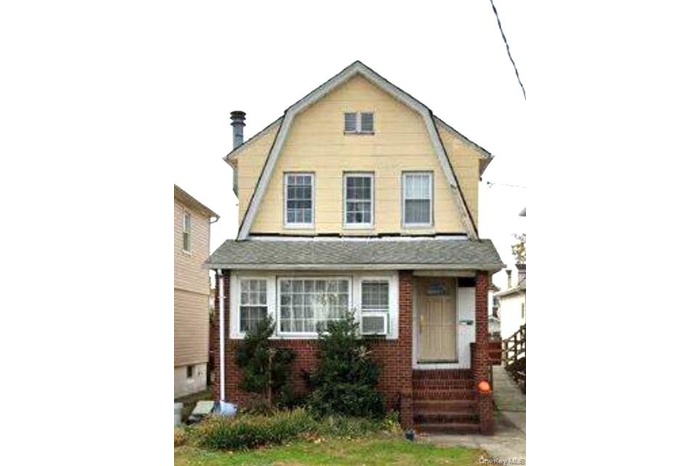 Dutch colonial featuring a gambrel roof and entry steps