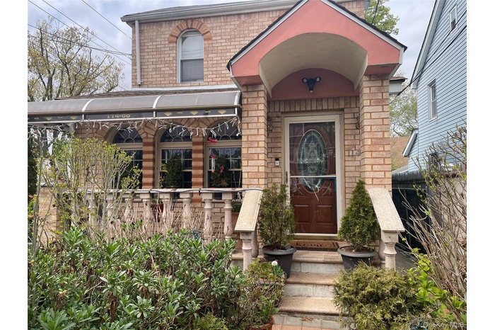View of exterior entry with brick siding
