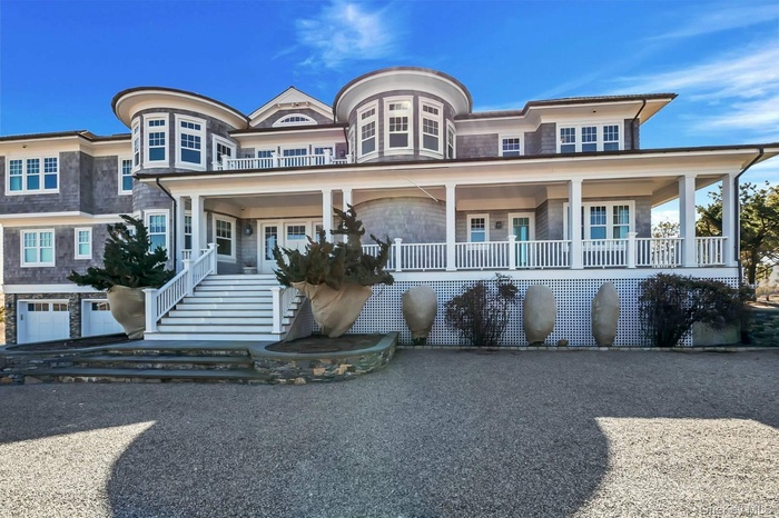 View of front facade featuring stairs and a large porch