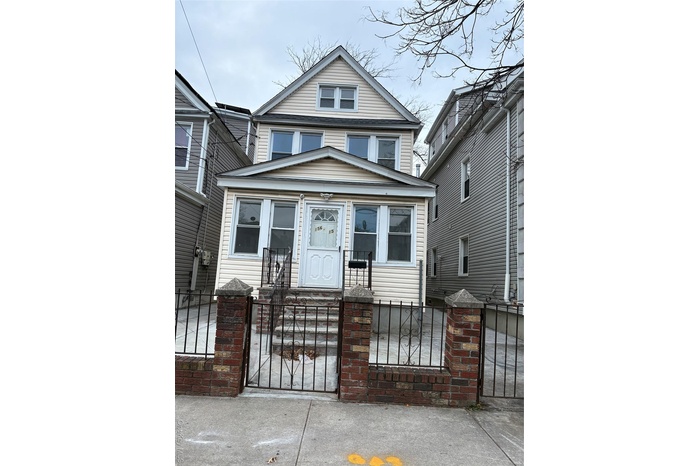 Traditional style home with a gate and a fenced front yard