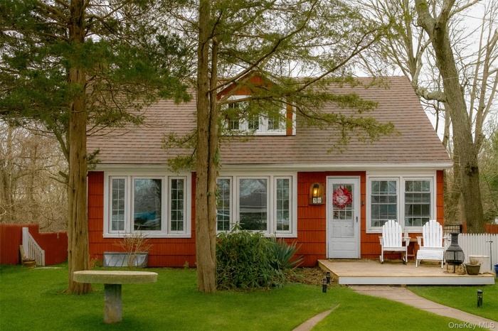 View of front of house with roof with shingles and a deck