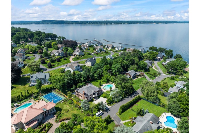 Aerial view of residential area featuring a nearby body of water